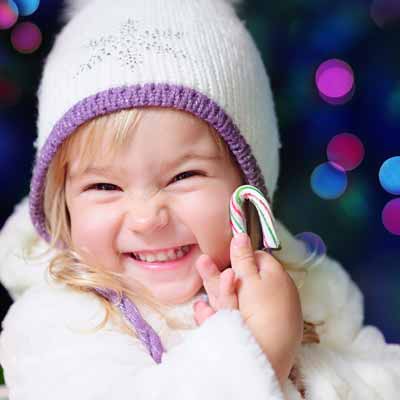 Little girl holding a candy cane