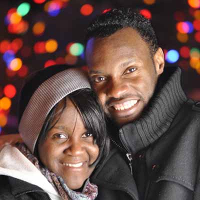 African American couple looking at Christmas lights together